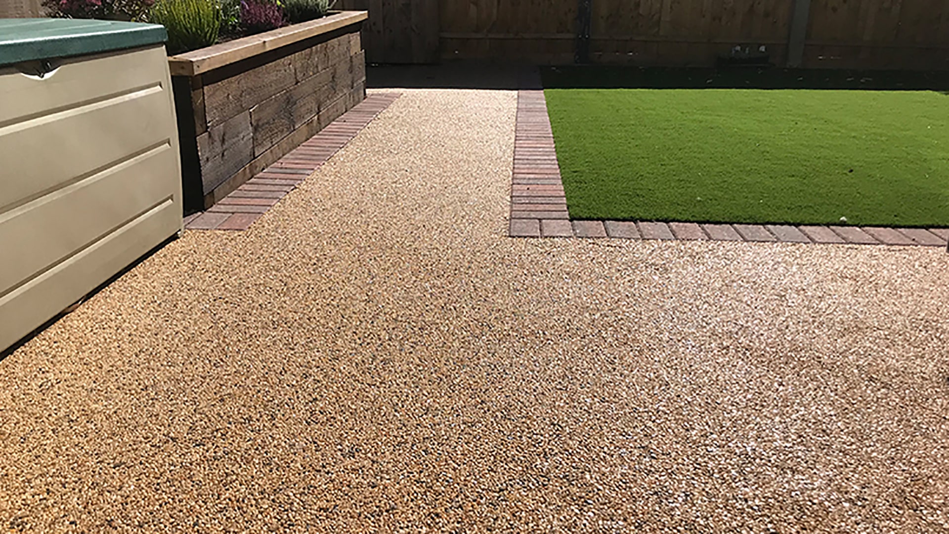 Resin-bound driveway beside a lawn